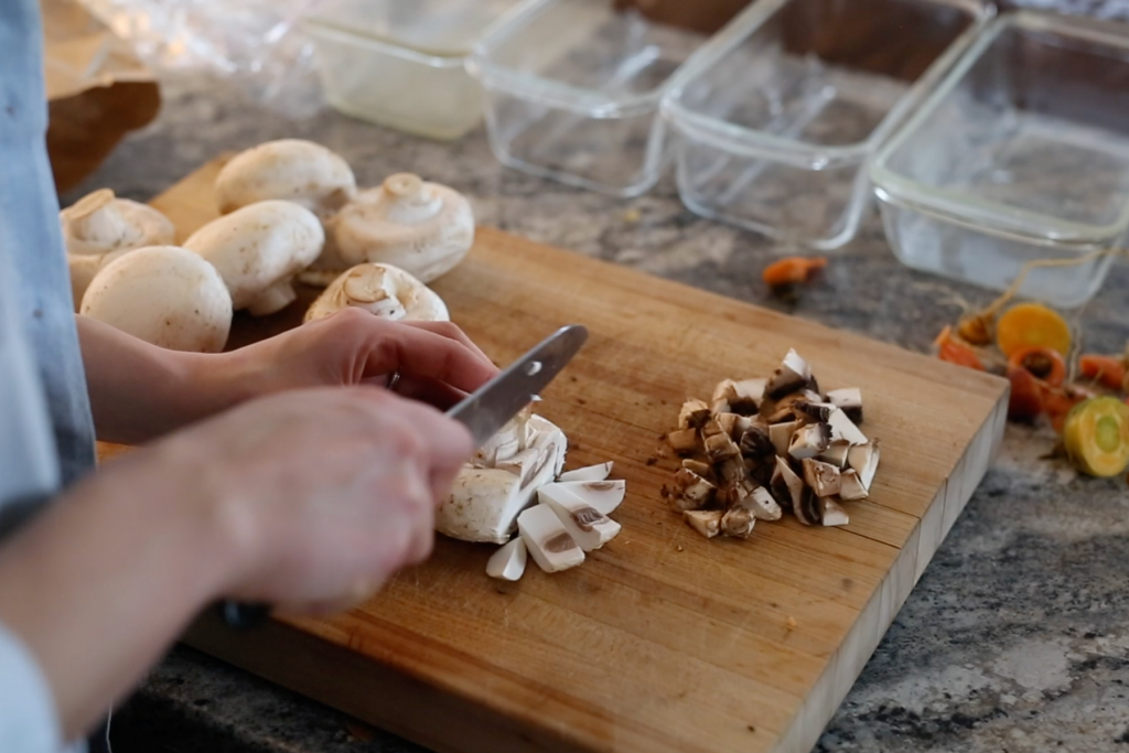 slice mushrooms on cutting board