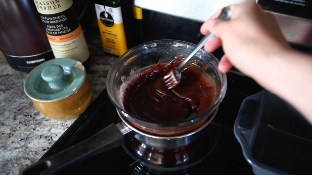 mixing chocolate and butter over a double boiler on stovetop