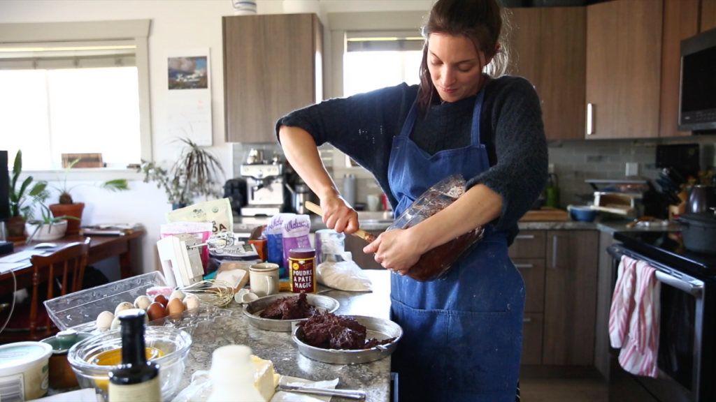 woman mixing brownie mix in bowl in modern kitchen