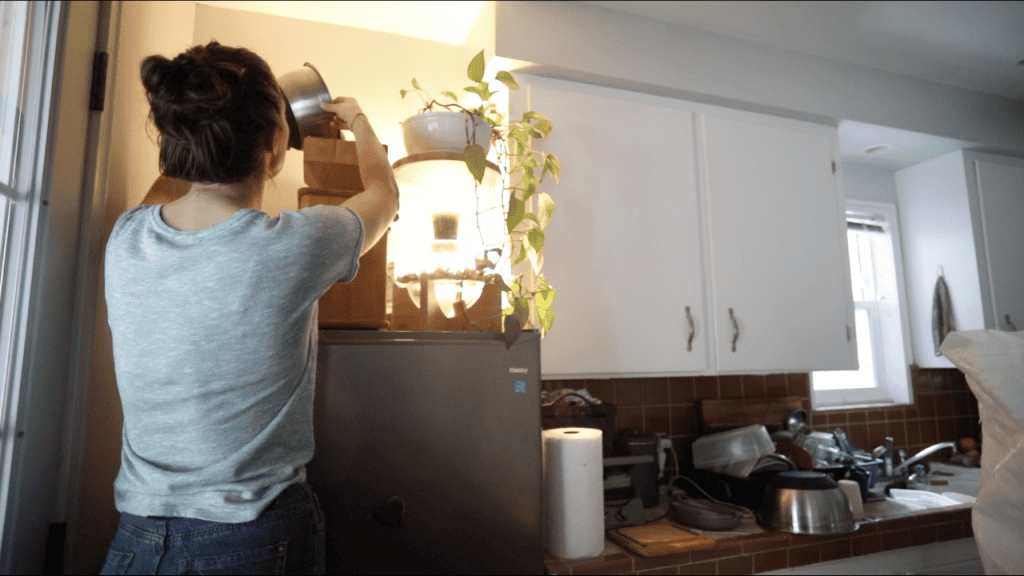 woman from behind milling flour fresh for sourdough recipe whole wheat