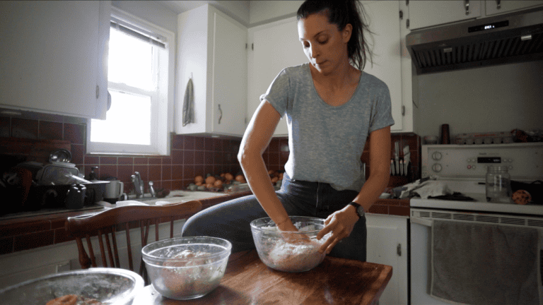 woman mixing sourdough recipe whole wheat in fall kitchen